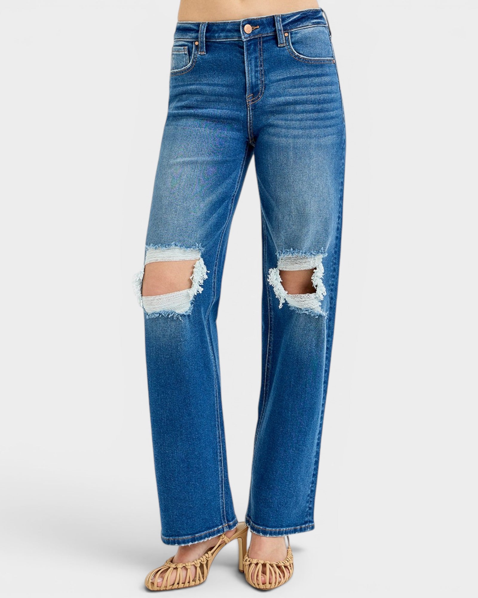 Blue jeans with distressed details on a white background