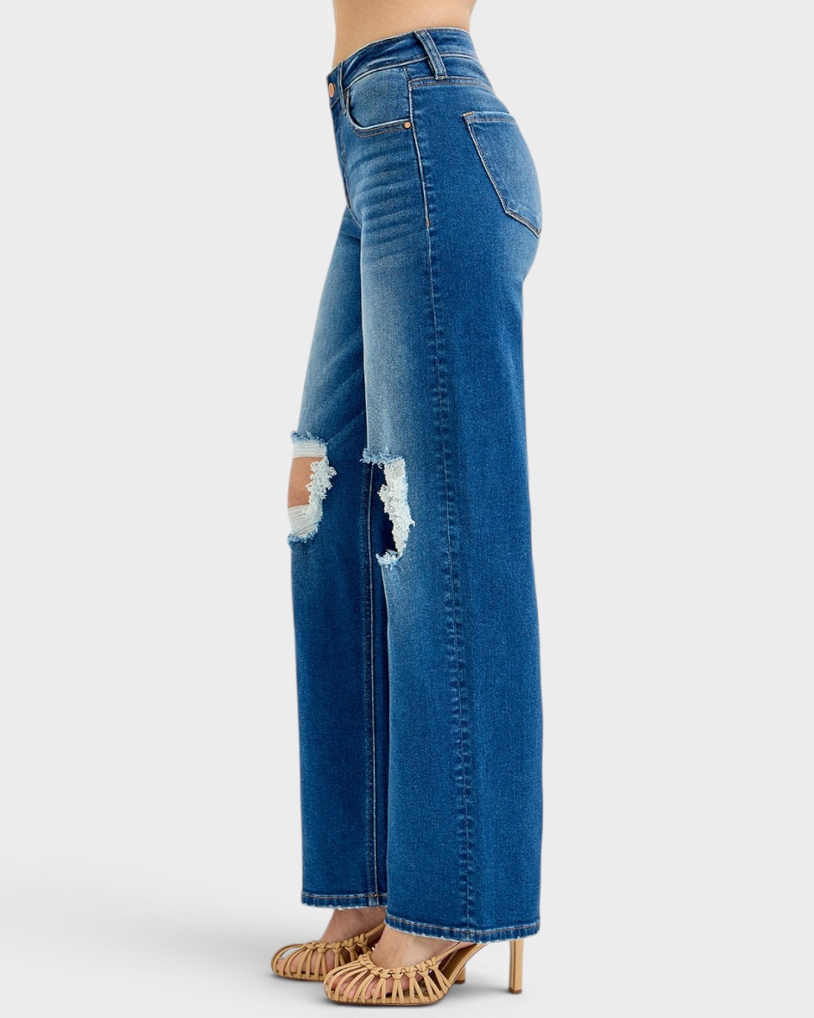 Blue jeans with a distressed design on a white background