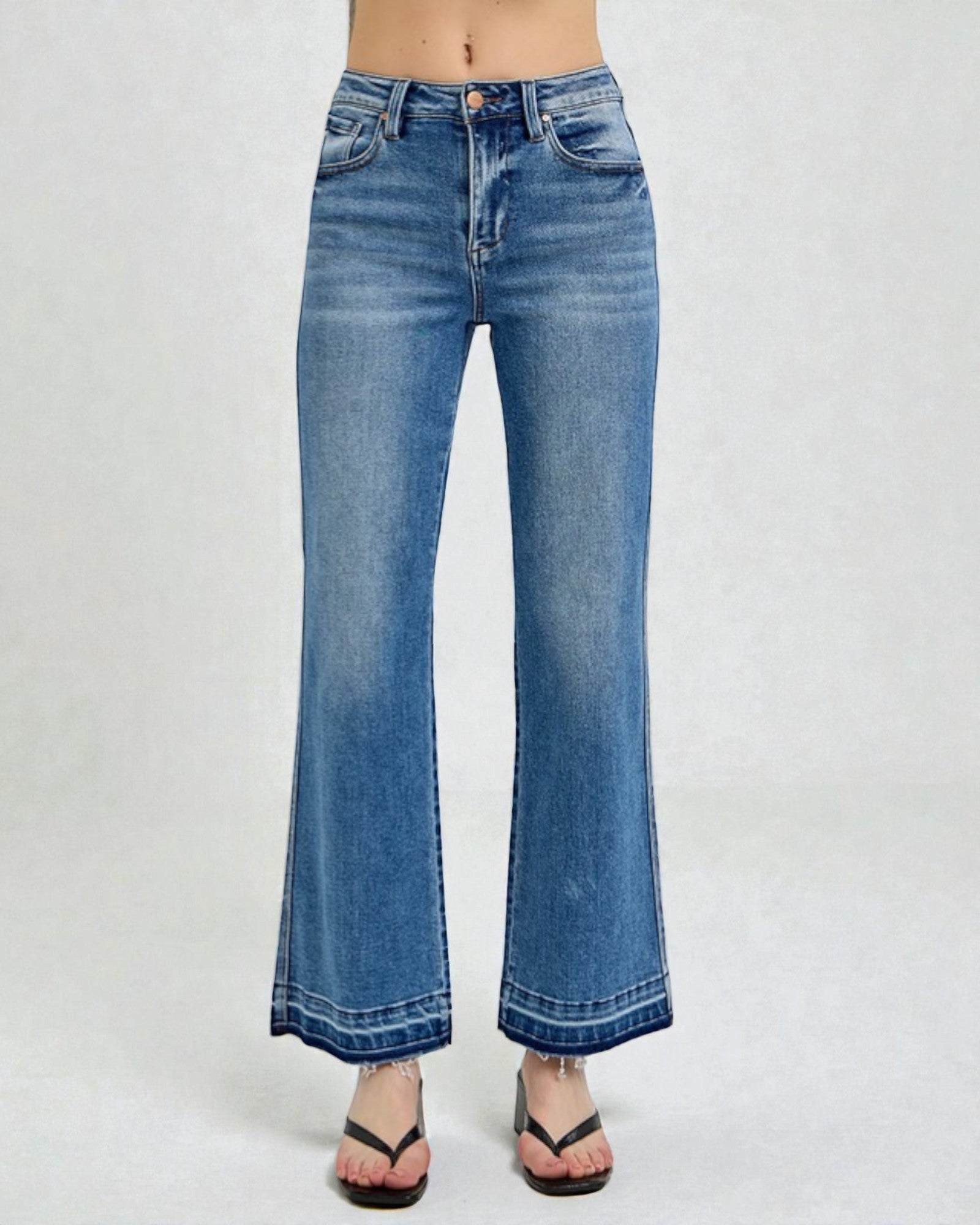 Blue jeans worn by a person on a white background