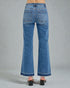 Blue jeans worn by a person on a gray background