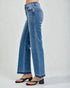 Blue jeans worn by a person on a white background