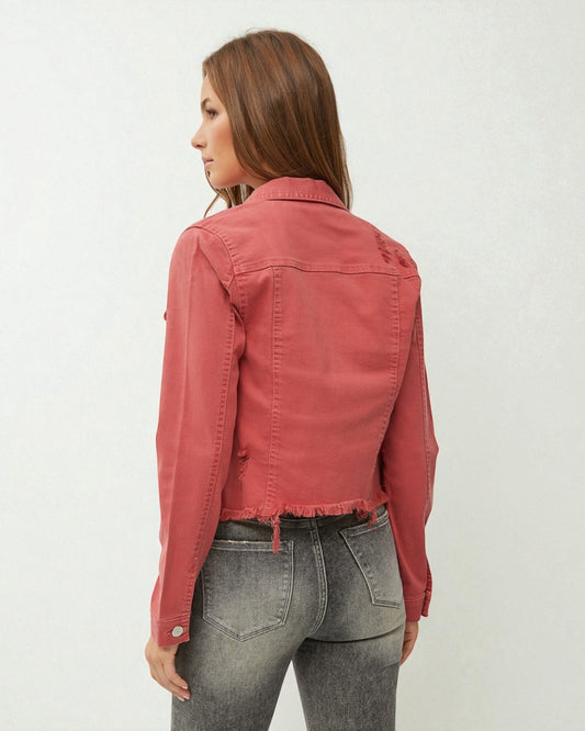 Person wearing a red denim jacket and gray jeans on a white background