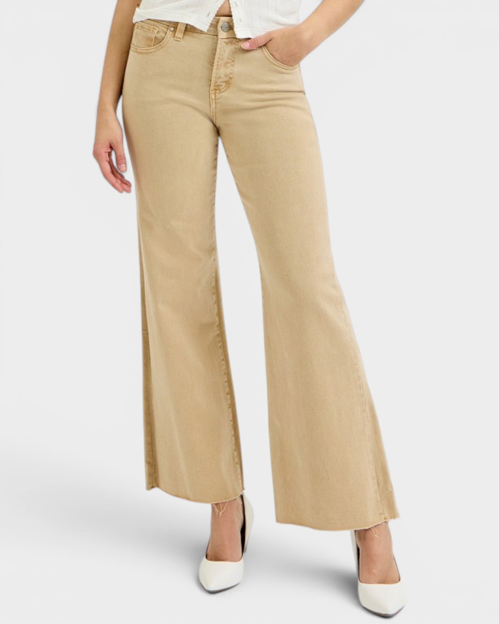 Person wearing beige wide-leg jeans on a white background