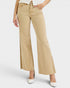 Person wearing beige wide-leg jeans on a white background