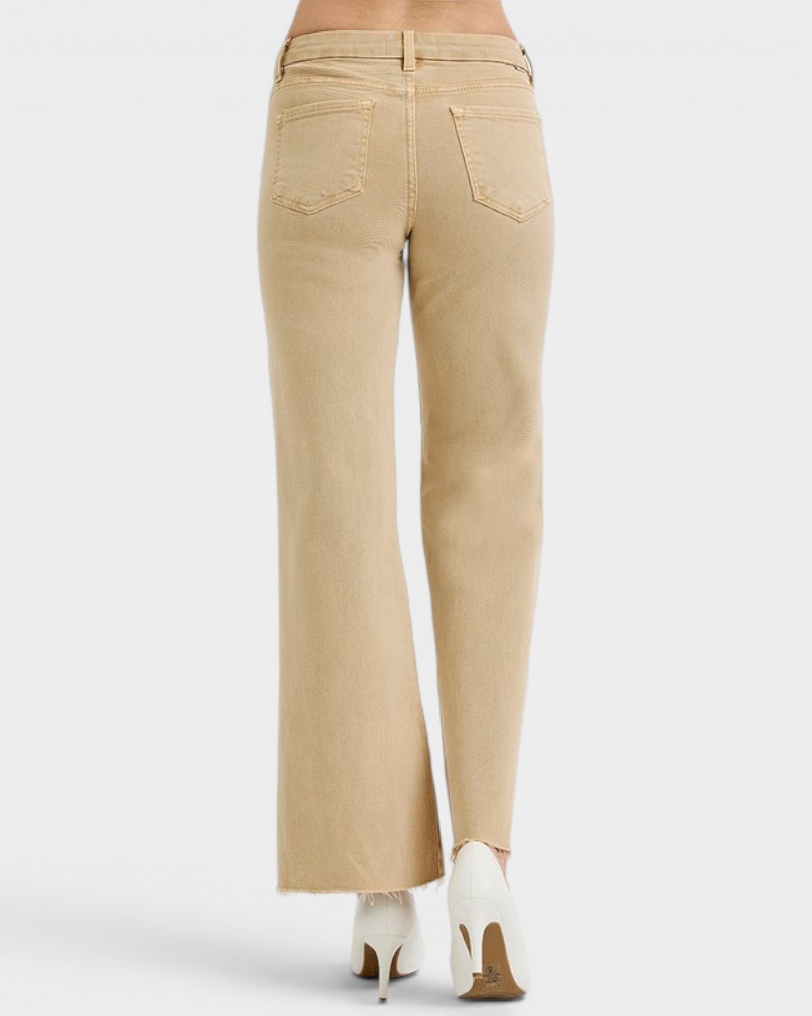 Beige pants worn by a person on a white background