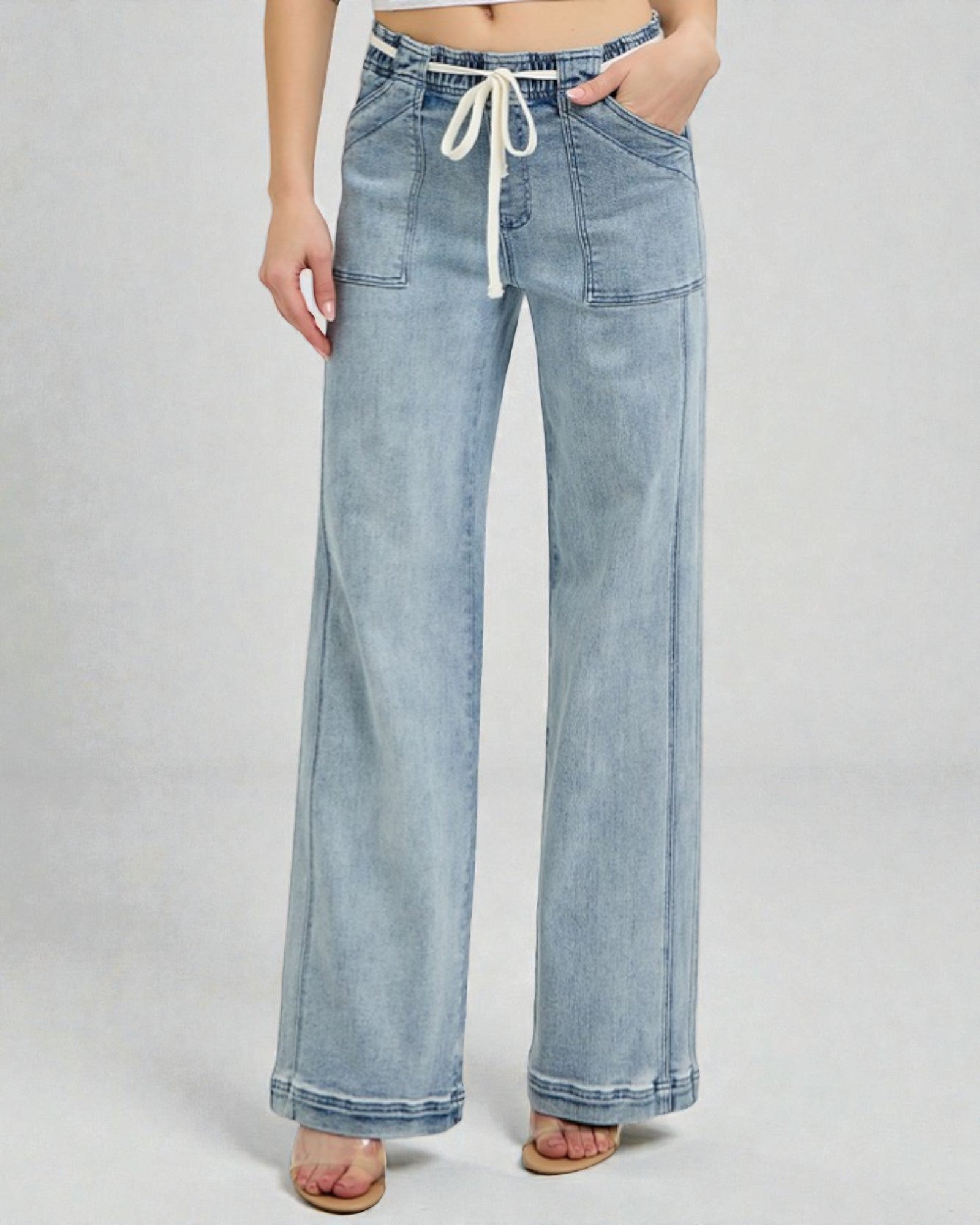 Light blue denim wide-leg pants with a drawstring waist on a white background