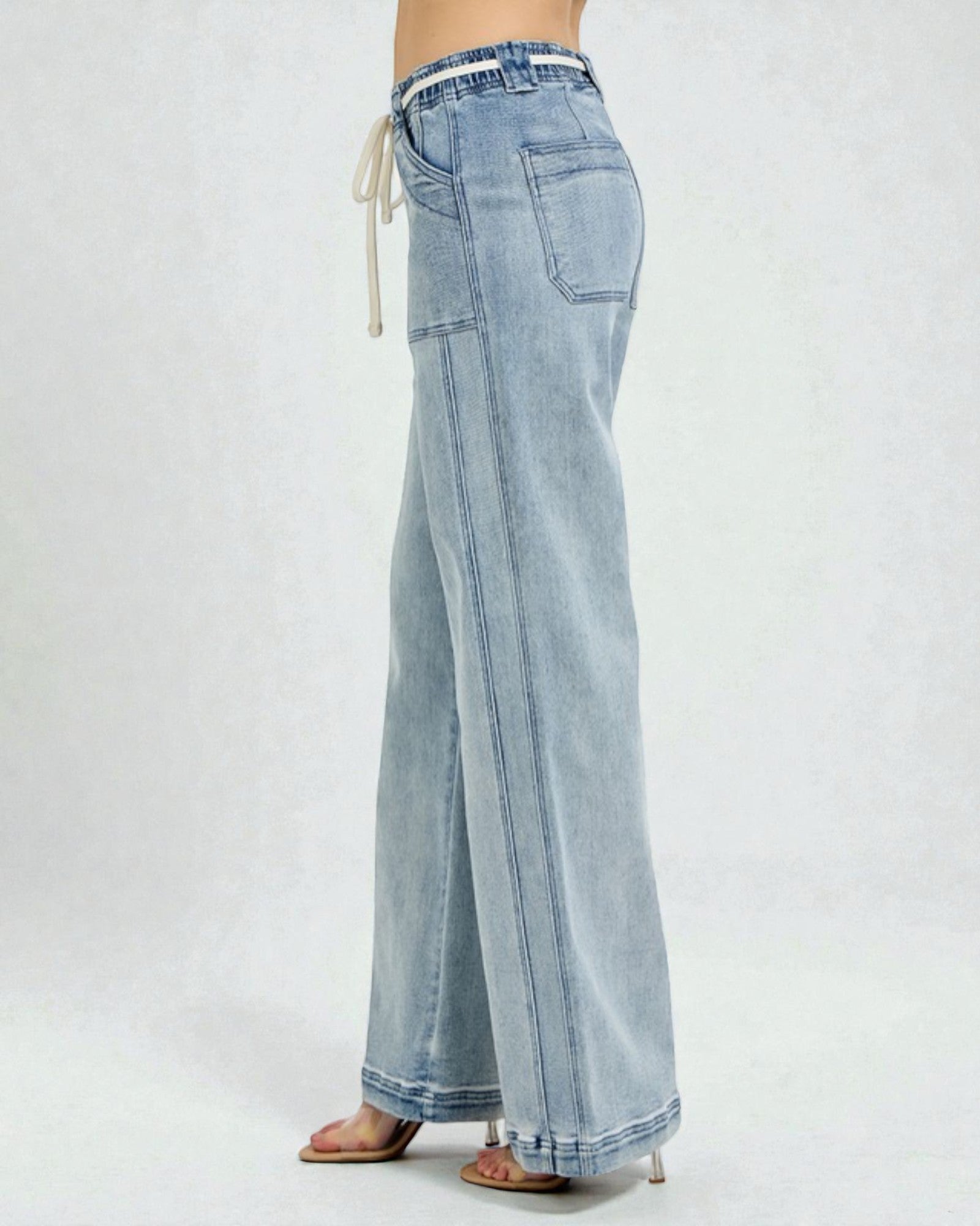 Light blue denim pants on a white background