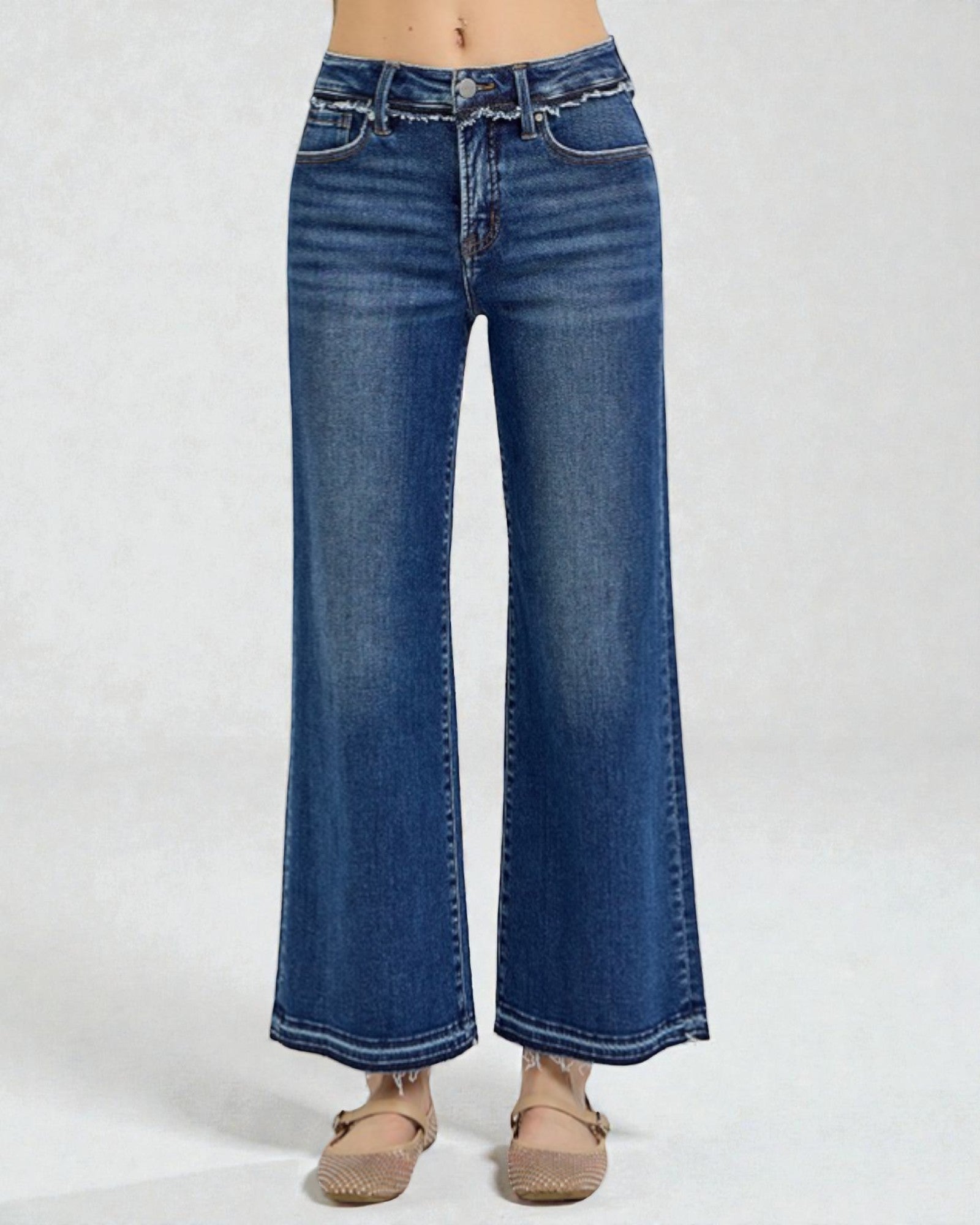 Blue jeans worn by a person on a white background