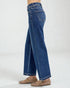 Blue jeans worn by a person on a white background