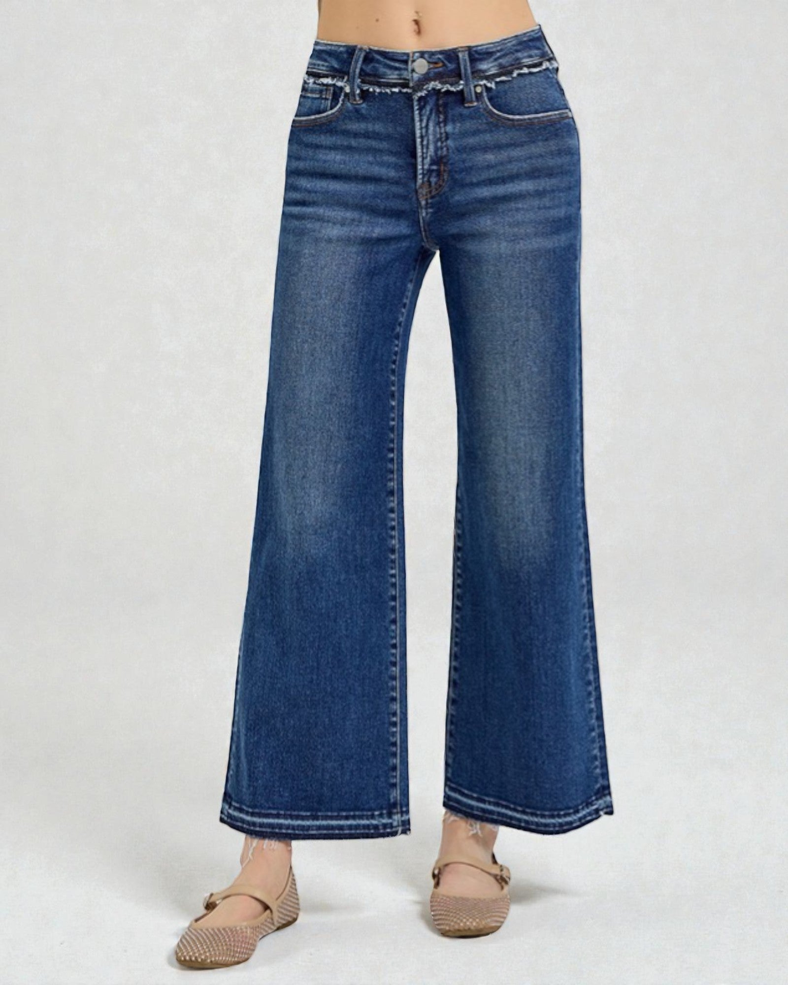 Blue jeans worn by a person on a white background
