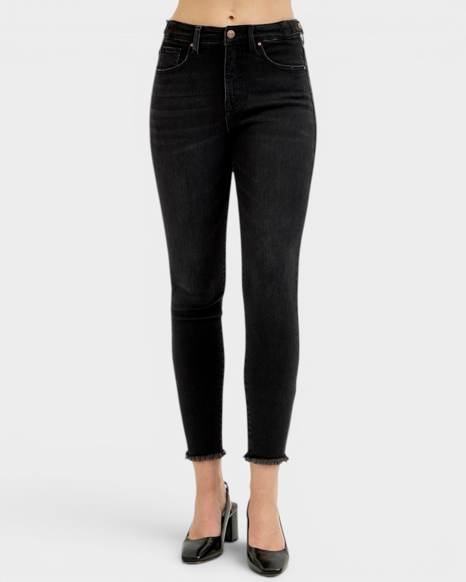 Black jeans worn by a person on a white background