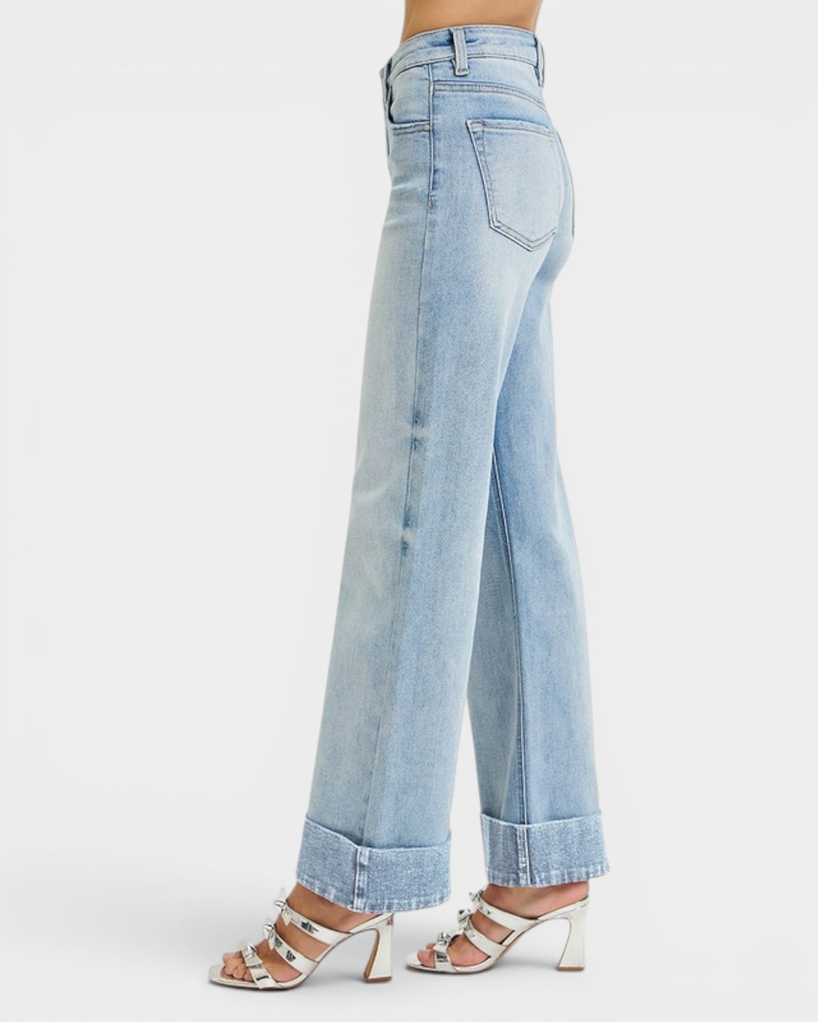 Light blue jeans worn by a person on a white background