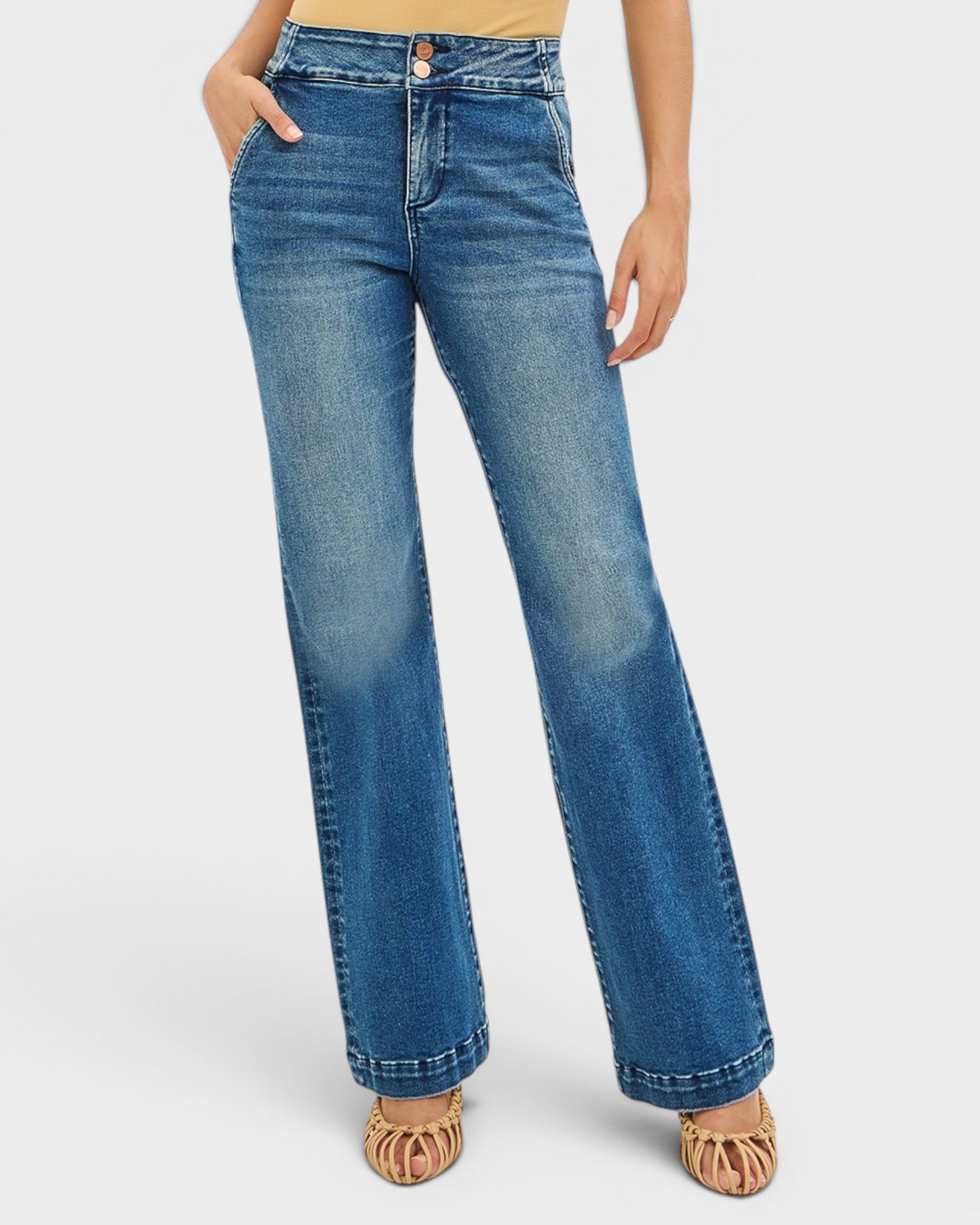 Blue jeans worn by a person on a white background