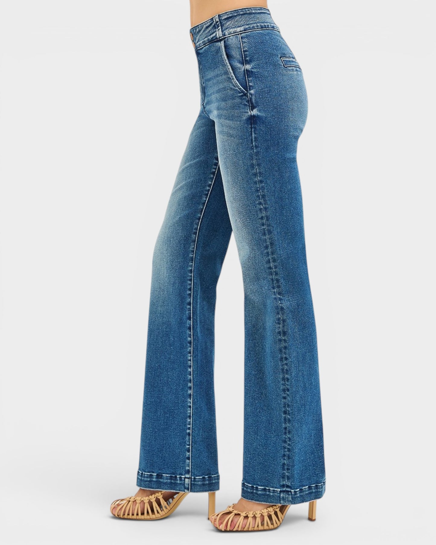 Blue jeans worn by a person on a white background