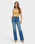 Woman wearing a yellow top and blue jeans on a white background