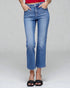 Person wearing blue jeans on a plain background