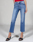 Person wearing blue jeans on a plain background