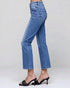 Blue jeans worn by a person on a plain background