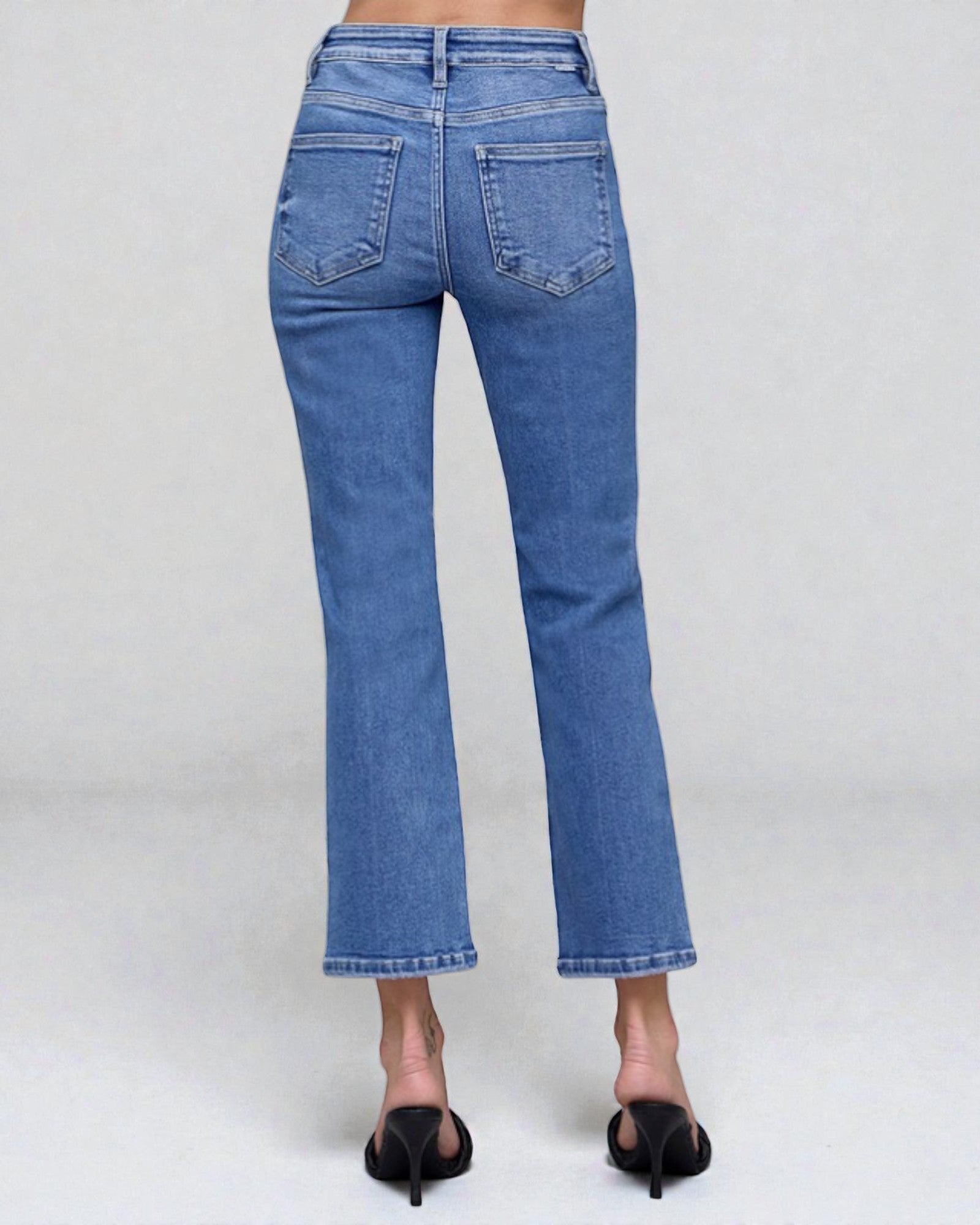 Blue jeans worn by a person on a white background