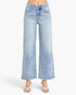 A person wearing light-wash blue wide-leg cropped jeans with a faded wash and white thong sandals, shown against a plain light gray studio background.