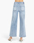 Light wash blue wide-leg denim jeans shown from the back on a model, featuring a high waist, back pockets, and a flared leg, paired with white heeled sandals against a plain white background.
