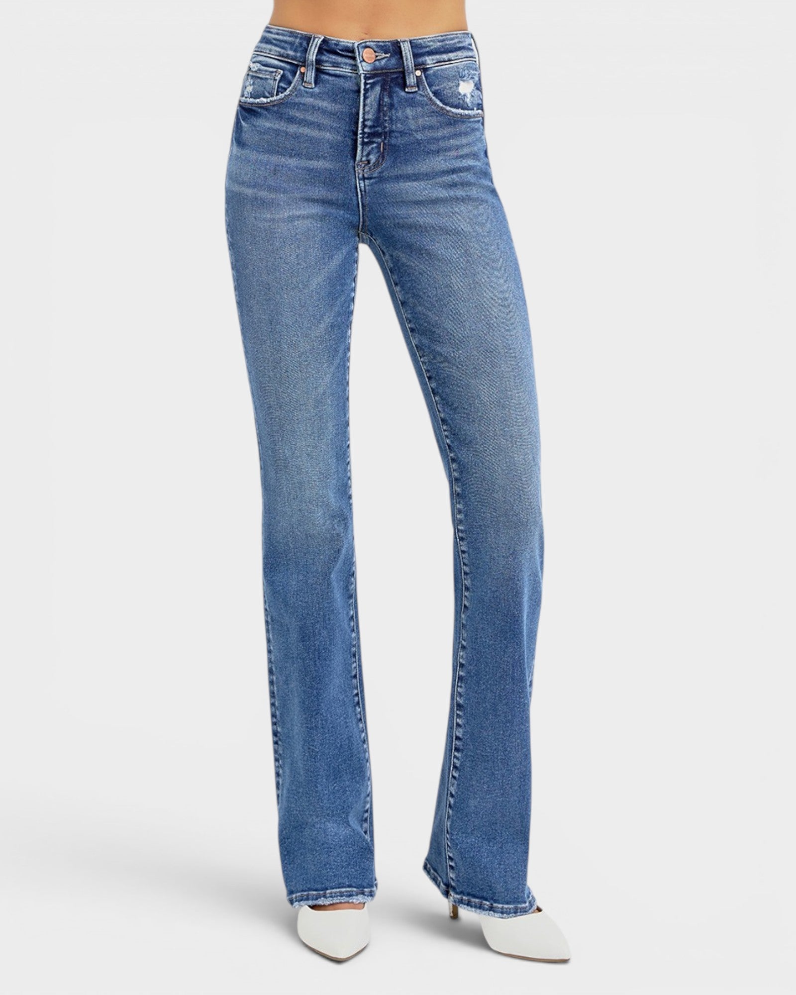 Blue jeans worn by a person on a white background