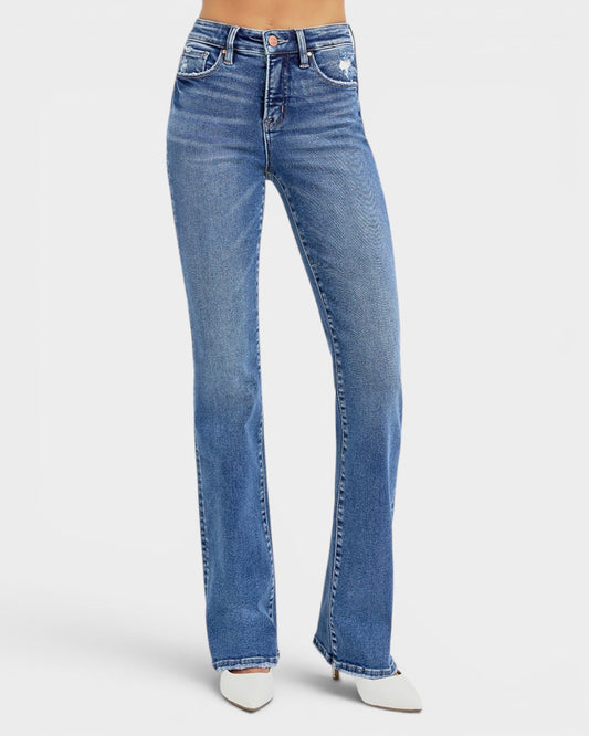 Blue jeans worn by a person on a white background