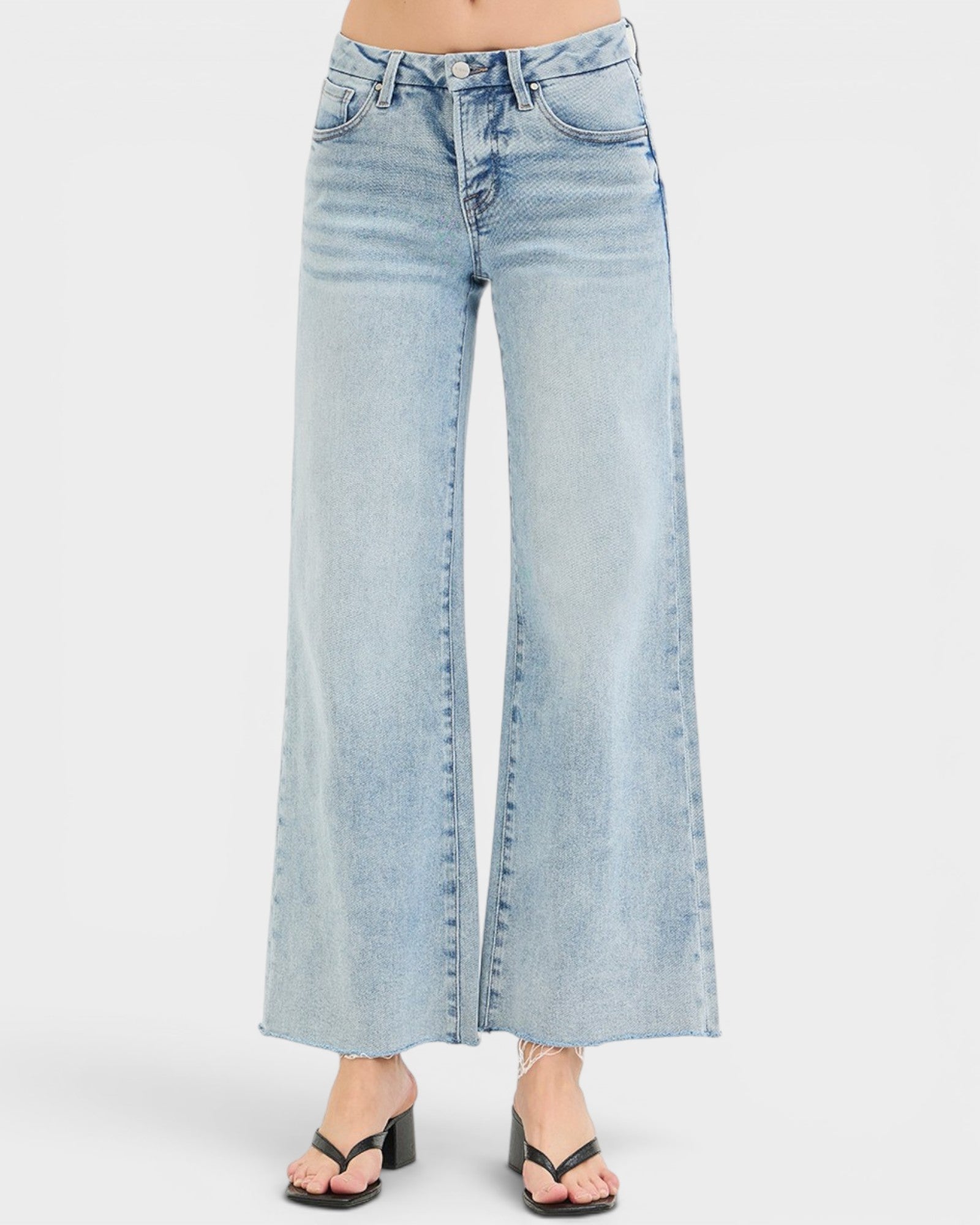 Light blue jeans worn by a person on a white background