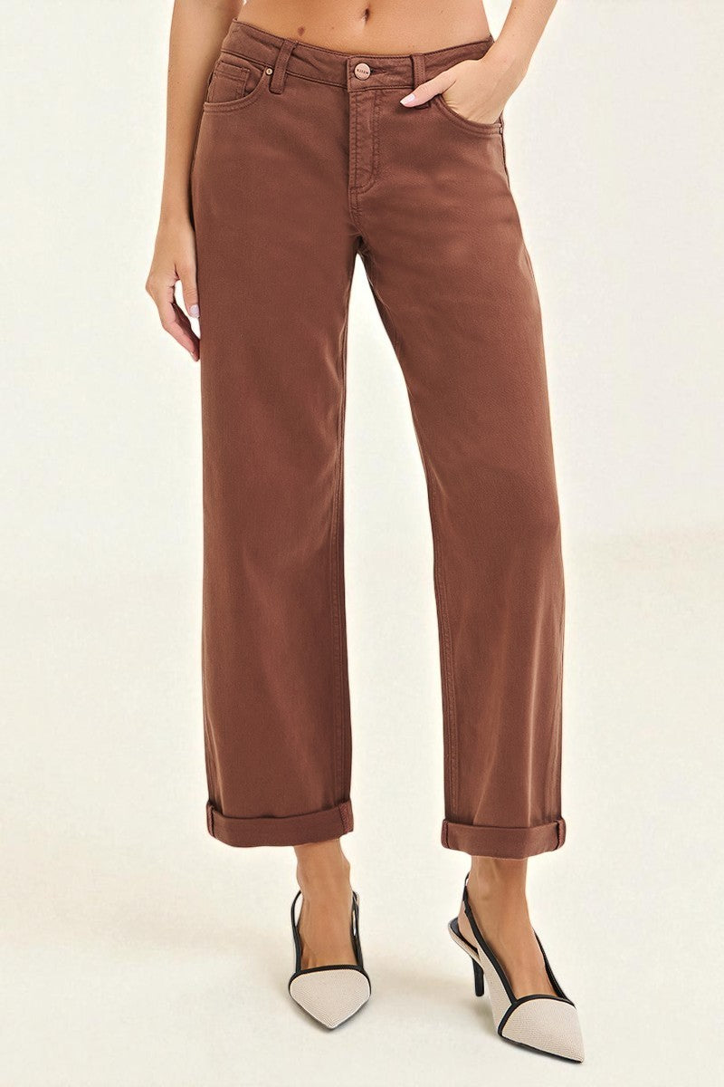 Brown pants worn by a person on a white background