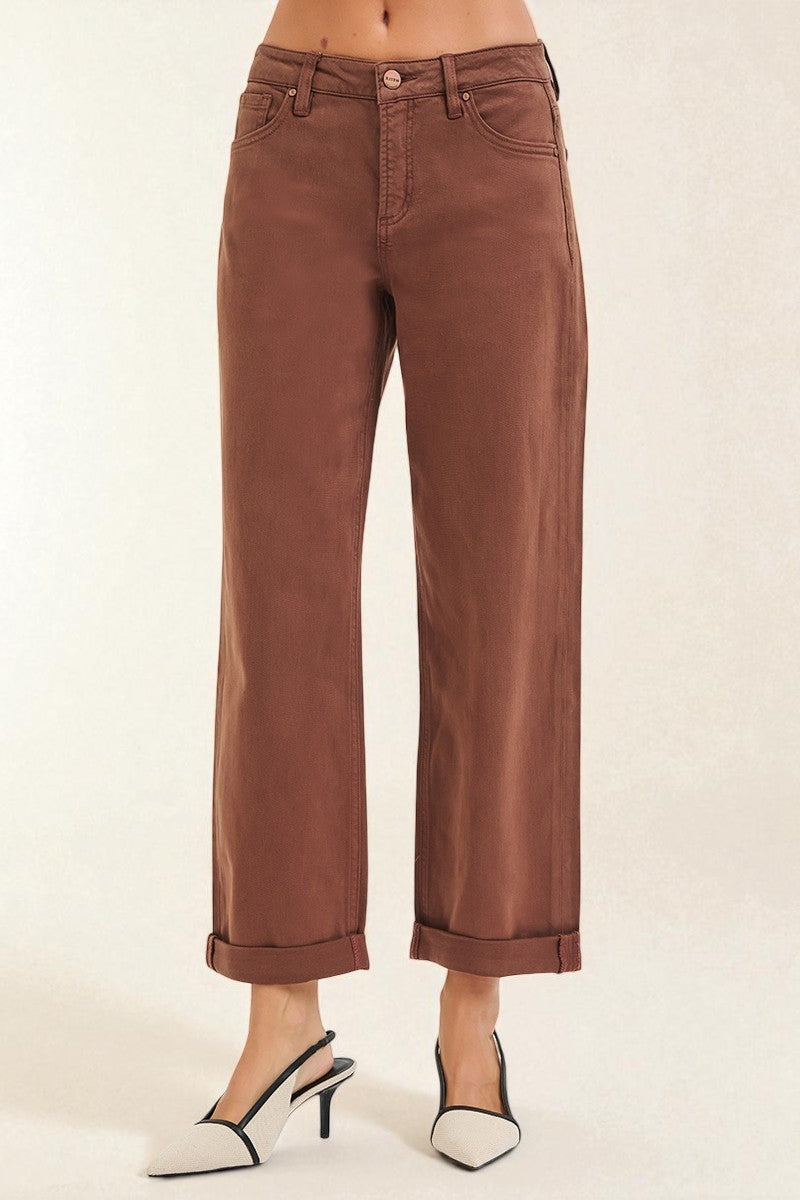 Brown pants worn by a person on a white background