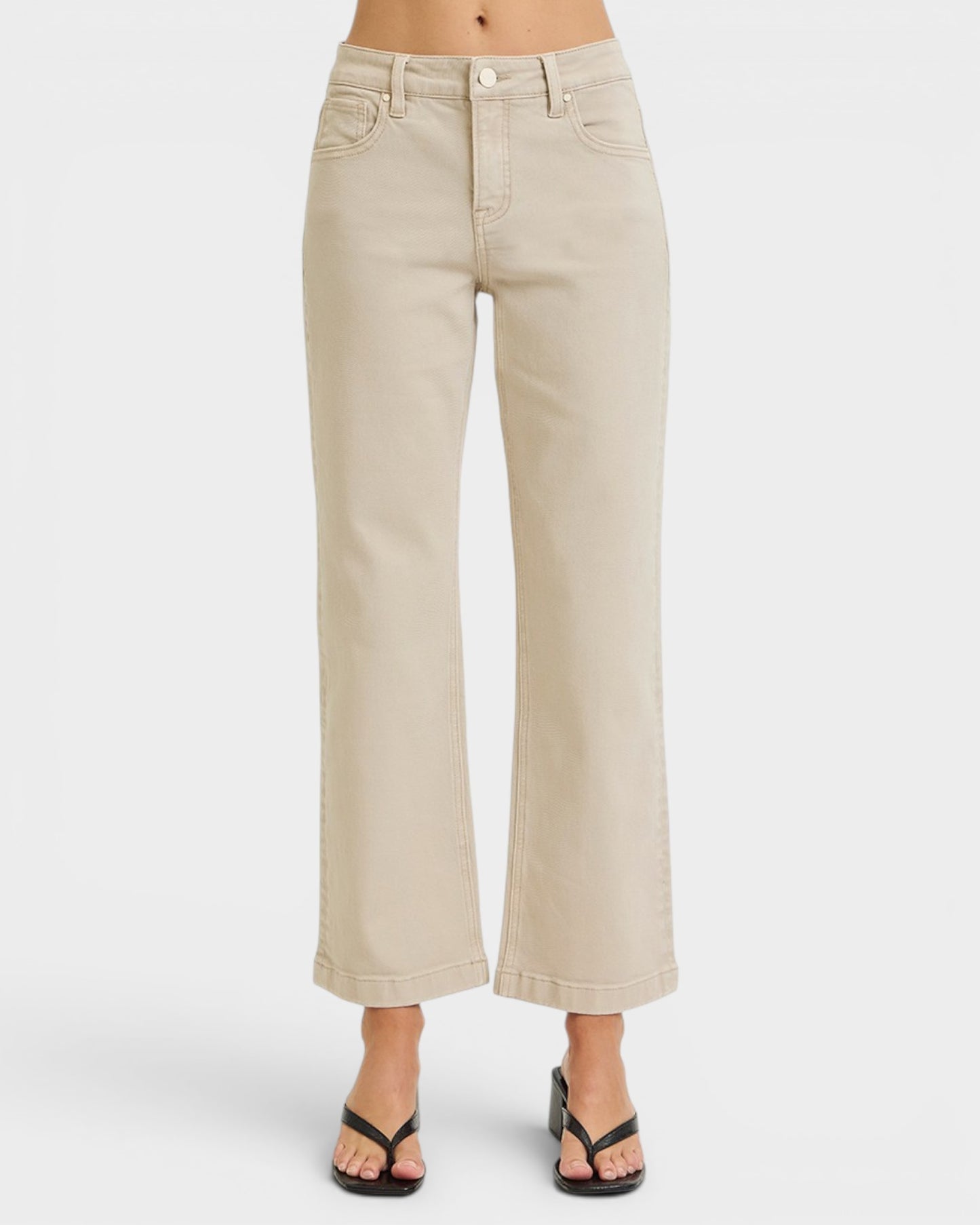 Beige jeans worn by a person on a white background