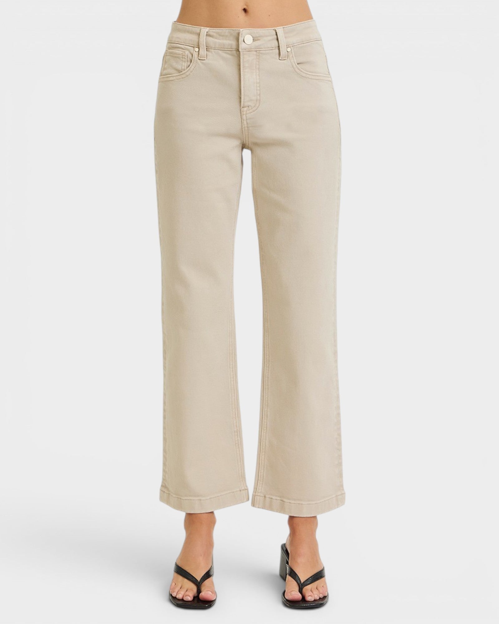 Beige jeans worn by a person on a white background