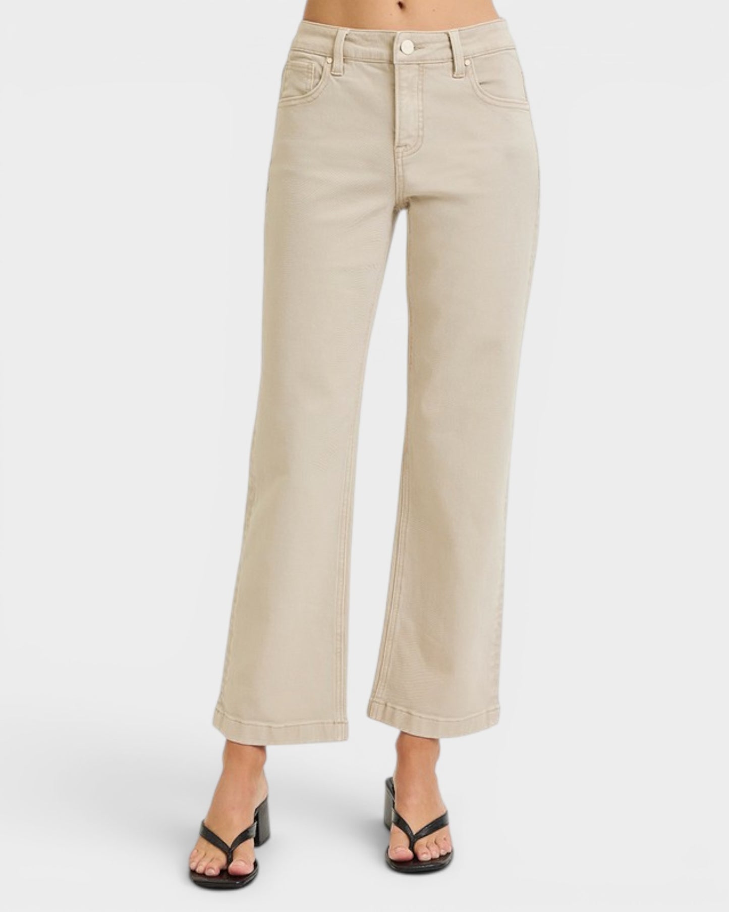 Beige wide-leg jeans worn by a person on a white background