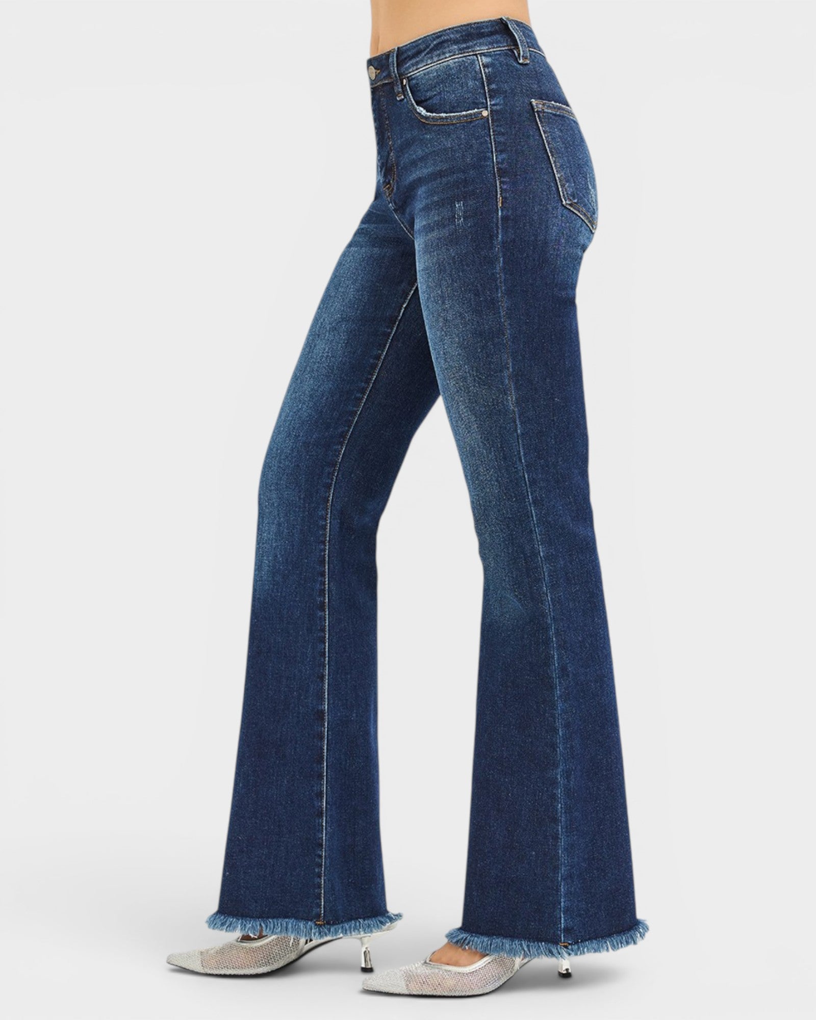 Blue jeans worn by a person on a white background