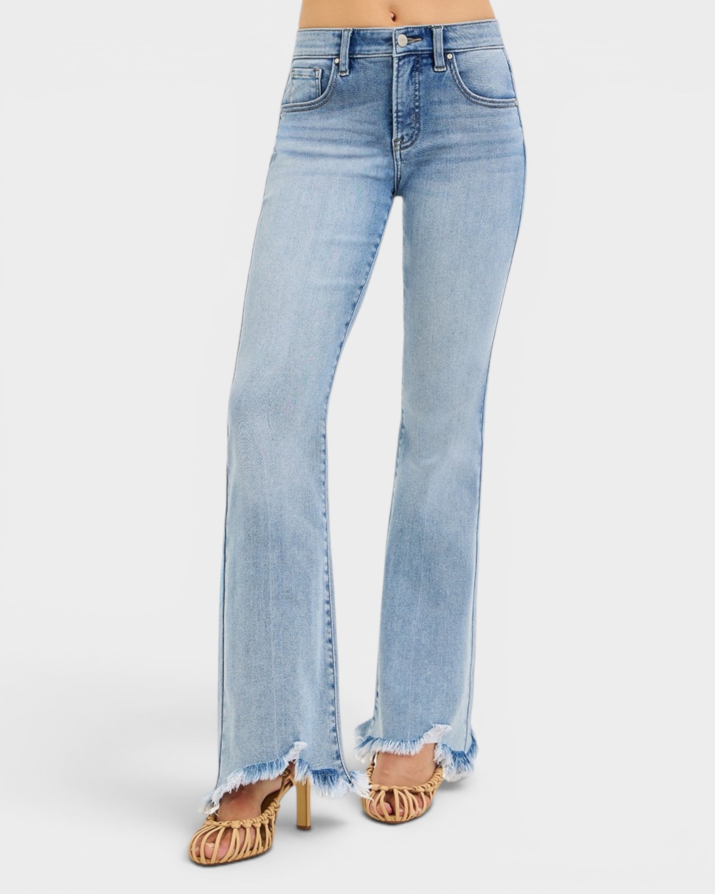 Light blue jeans with frayed hem on a white background