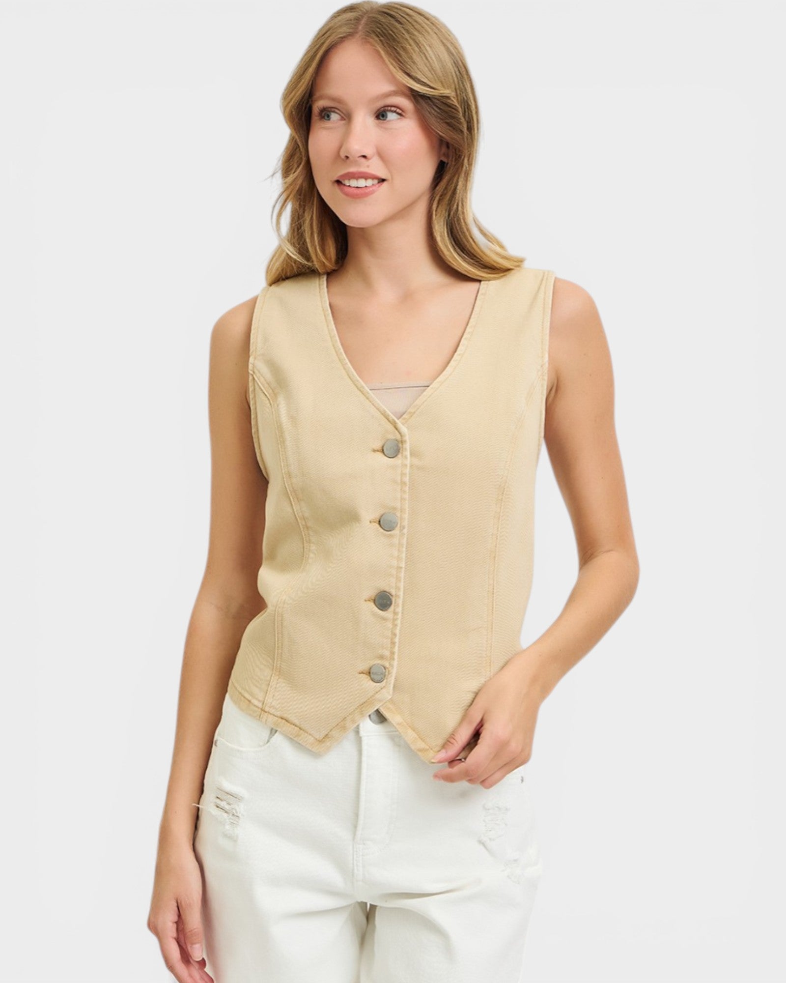 Woman wearing a beige vest on a white background