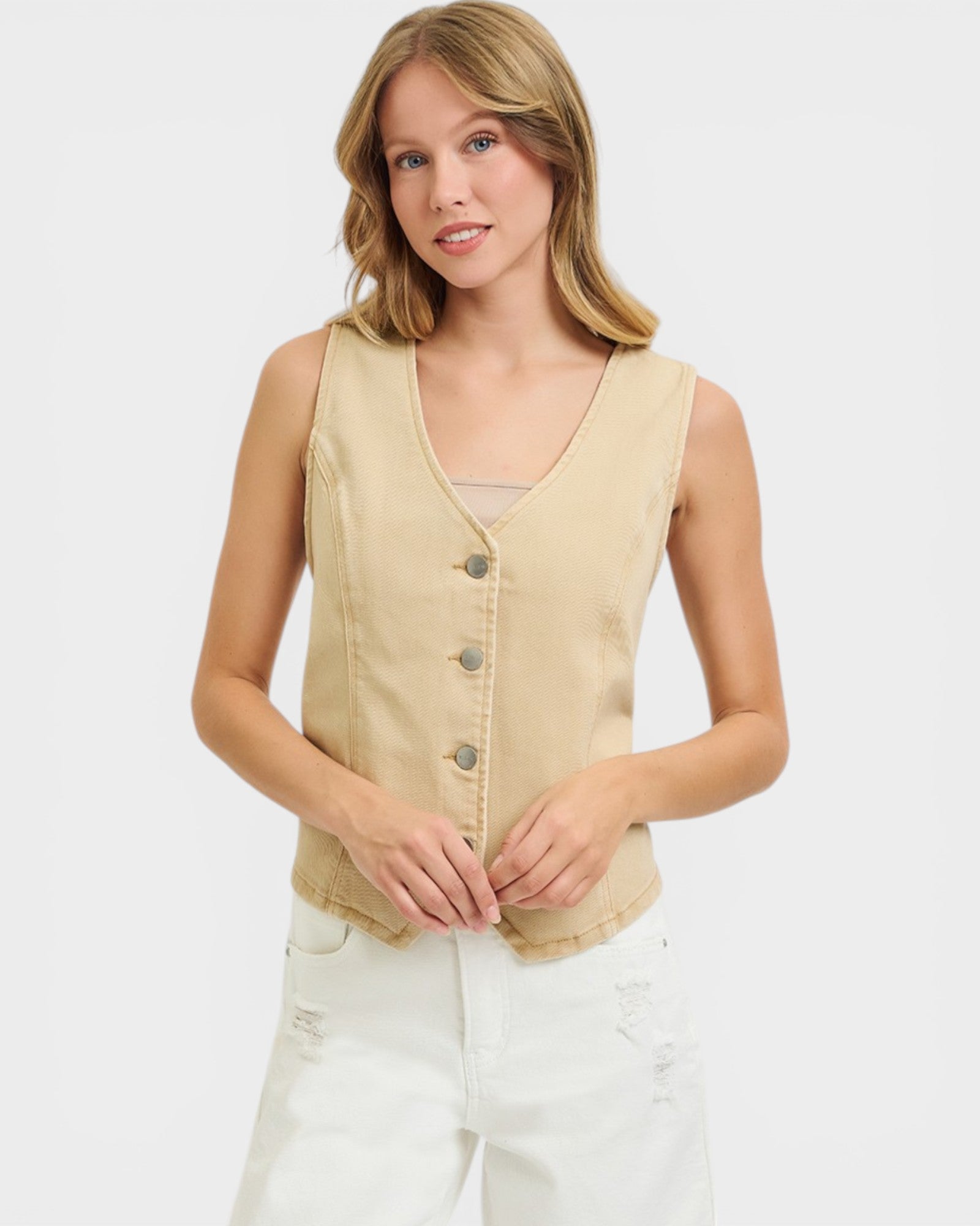 Woman wearing a beige vest on a white background
