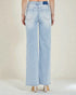 Light blue jeans worn by a person on a plain background