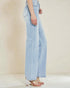 Light blue jeans worn by a person on a plain background