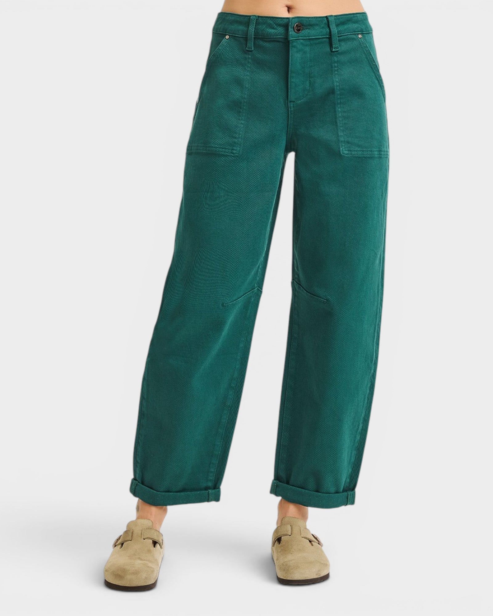 Green pants worn by a person on a white background