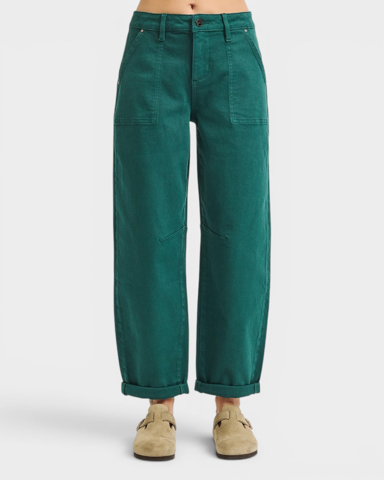 Green pants worn by a person on a white background