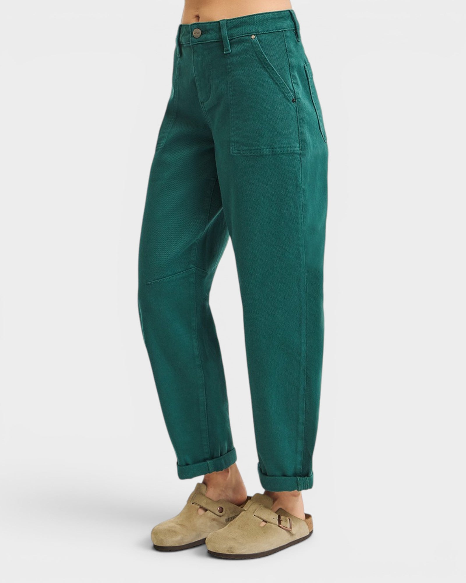 Green pants worn by a person on a white background
