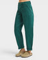 Green pants worn by a person on a white background