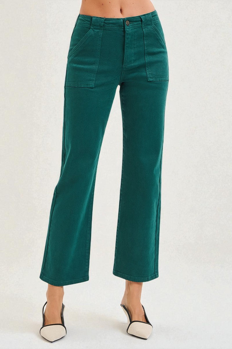 Teal pants worn by a person on a white background