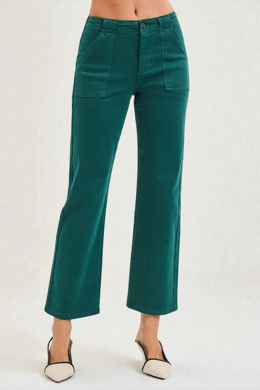 Teal pants worn by a person on a white background