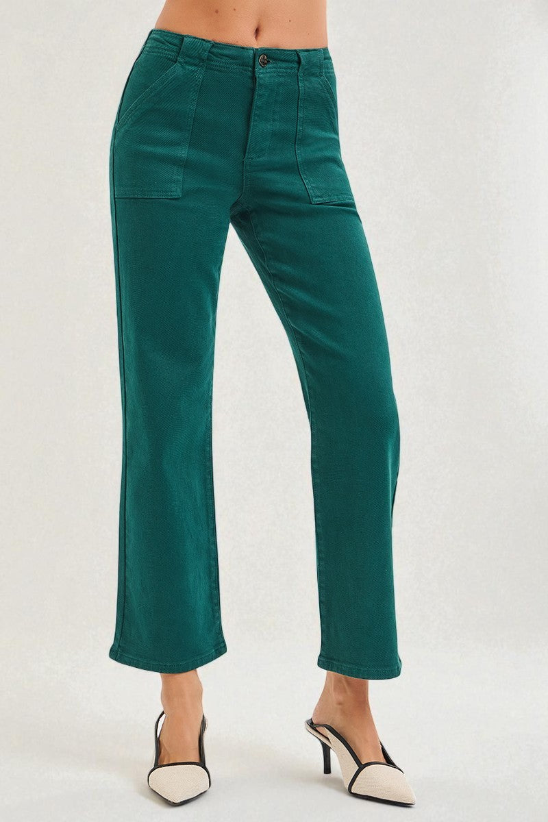 Teal pants worn by a person on a white background