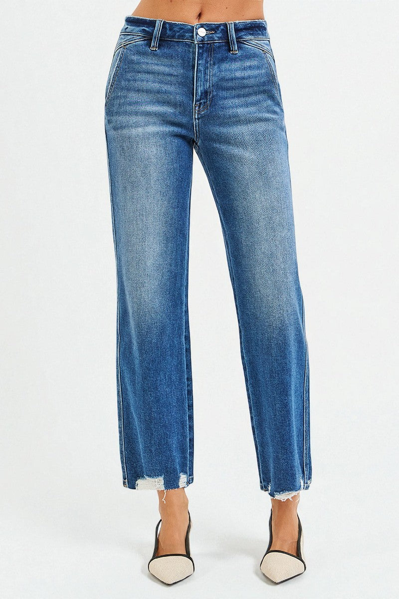 Blue jeans worn by a person on a white background