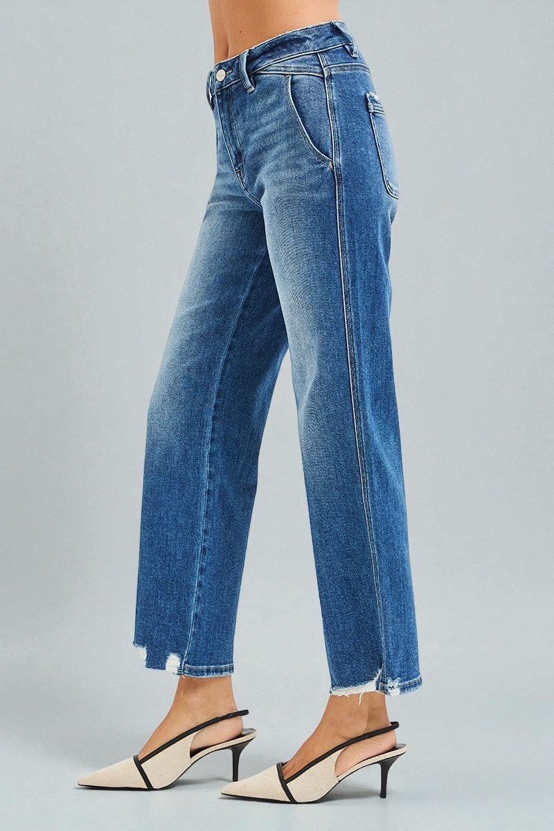 Blue jeans worn by a person on a gray background