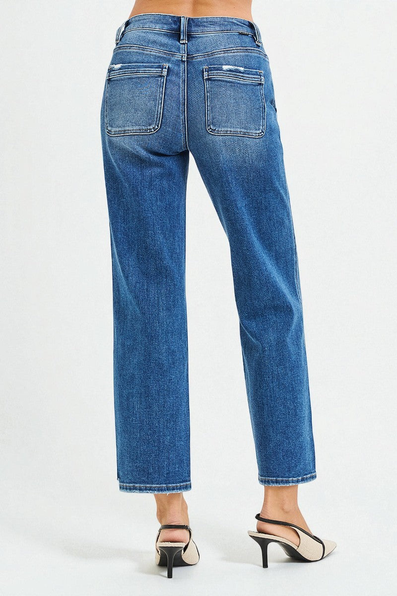 Blue jeans worn by a person on a white background