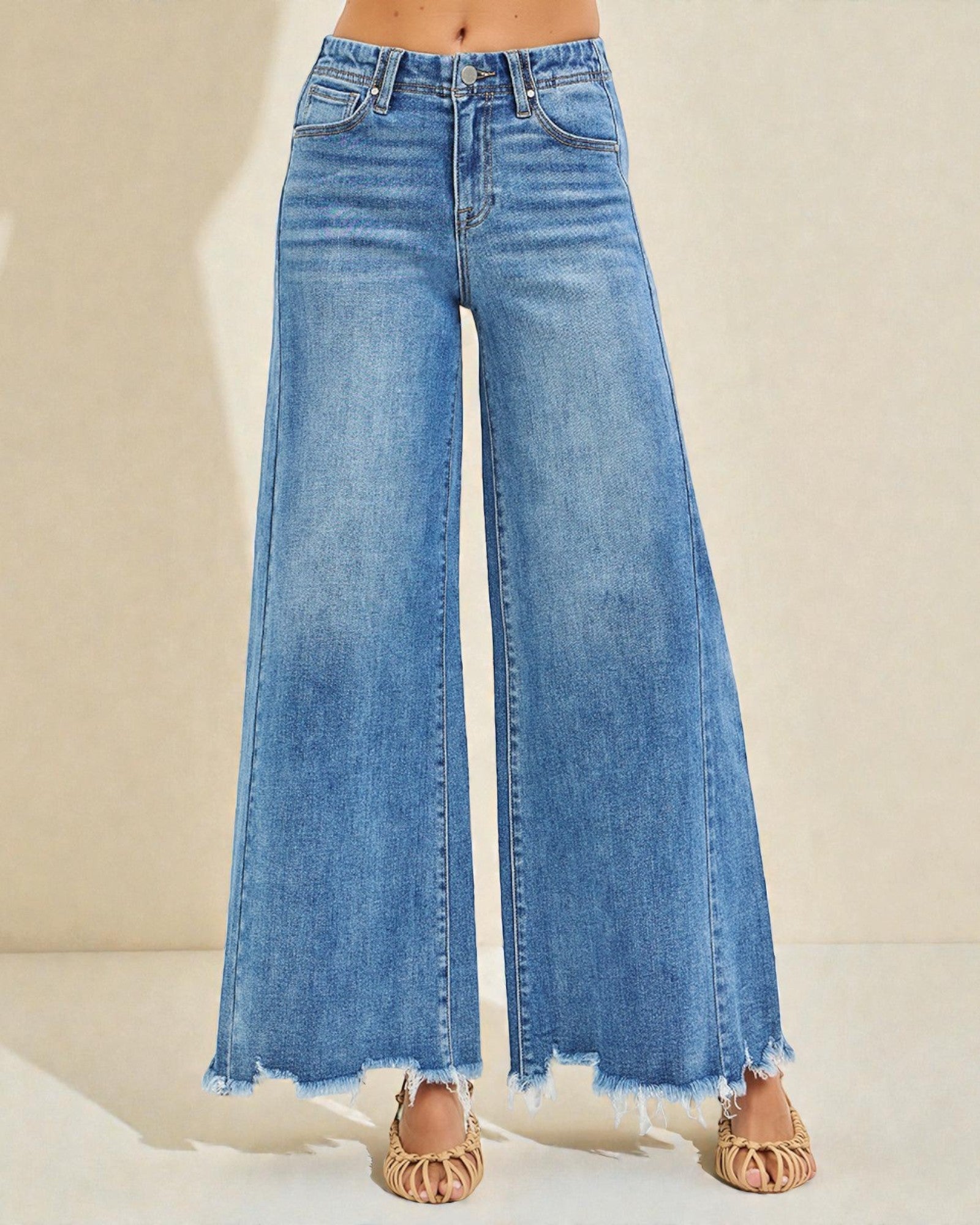 Blue wide-leg jeans on a neutral background